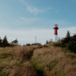 white and red lighthouse under blue sky during daytime