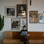 woman in black long sleeve shirt sitting on brown wooden chair